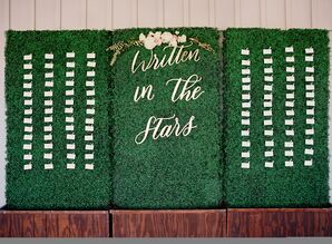 Greenery Covered Escort Card Wall with Laser-Cut Sign