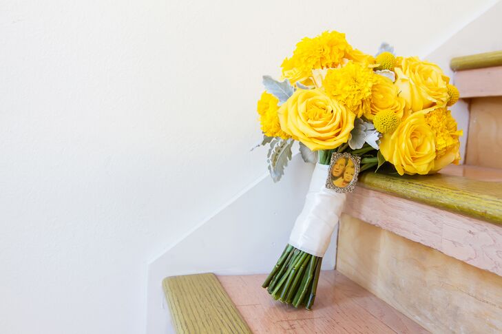 The bride's favorite color is bright yellow, so she carried a bouquet of yellow roses and marigolds with dusty miller.