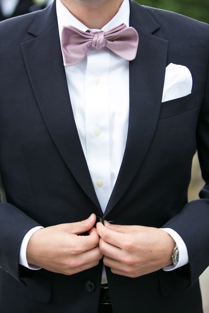 Each groomsmen wore classic navy suits paired with pastel bow ties that matched the pink Bill Levkoff bridesmaid dresses.