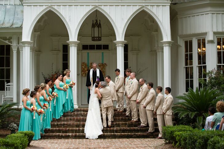 Madeline knew she wanted her bridesmaids in high-low dresses for the destination wedding at Rose Hill Mansion in Bluffton, South Carolina. She found bright, bold teal dresses by Bari Jay that were absolutely perfect. The groomsmen wore casual khaki suits from Lord West to fit the semi-casual, chic wedding.