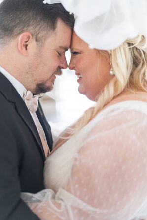 Bride and Groom Head-to-Head in a Sheer-Sleeved Dress and Dark Gray Suit
