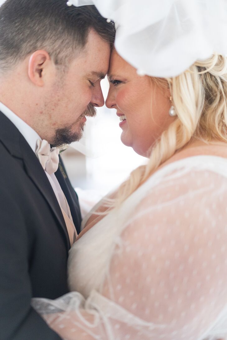 Bride and Groom Head-to-Head in a Sheer-Sleeved Dress and Dark Gray Suit