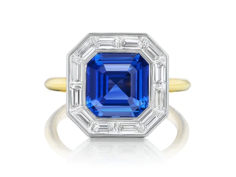 A hexagonal sapphire flanked by diamonds.
