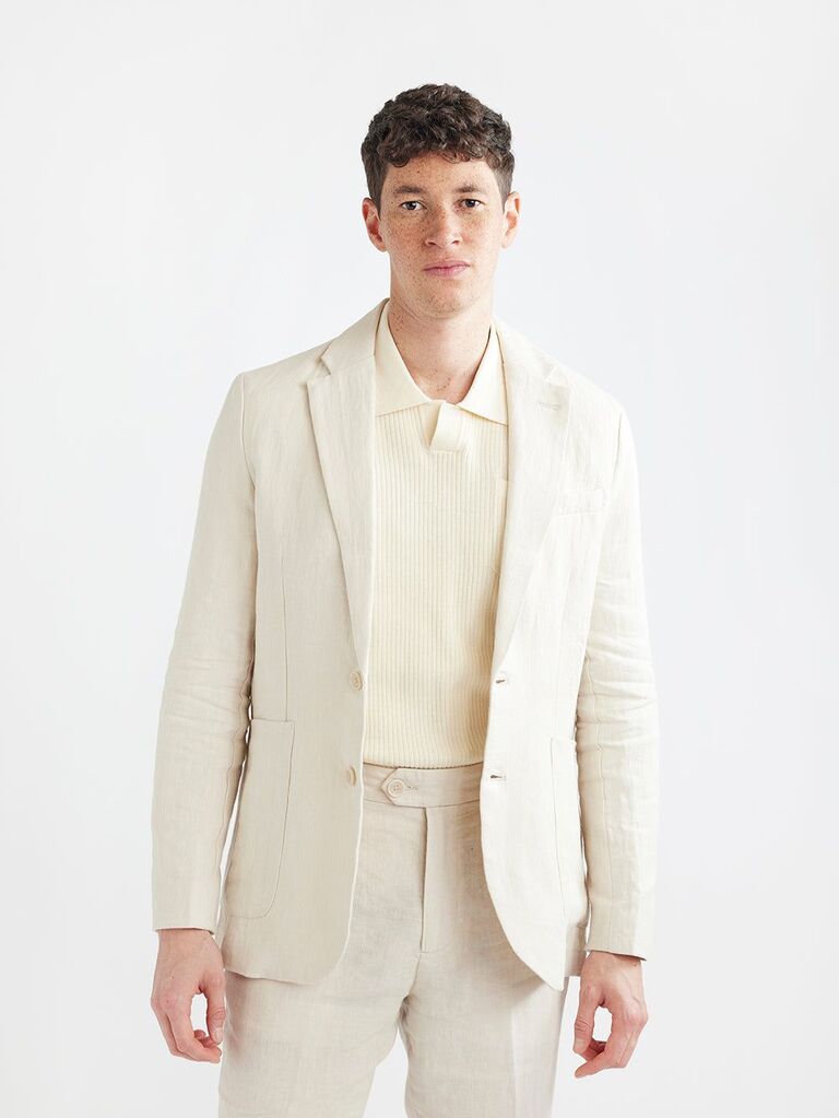 Model wears a relaxed linen suit jacket. 