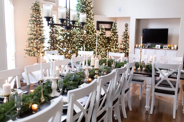 Simple White Reception with Greenery, Candles and Lit Christmas Trees
