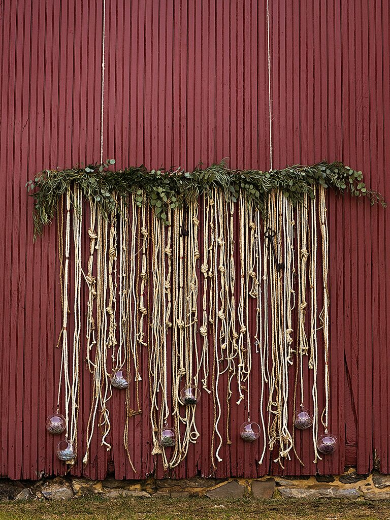 Eucalyptus garland with knotted gold rope wedding ceremony backdrop