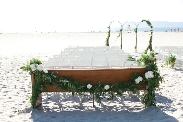 "One of my favorite details that day were the two old church pews we had as the last two rows of seating," Bayley says. "The backs were draped with more greenery and white flowers. It looked like they had been there forever and the greenery justrngrew up around it."