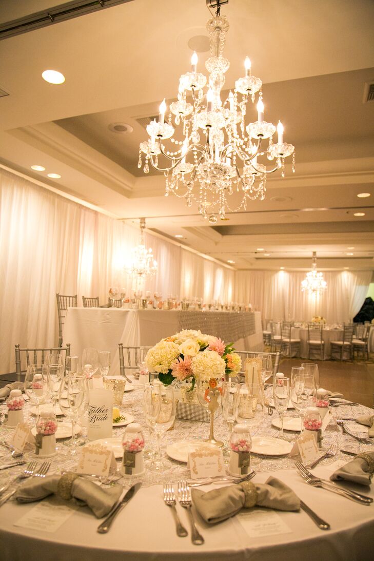 At the elegant ballroom reception, tables were decorated with ivory and pink centerpieces of hydrangeas, dahlias and roses.
