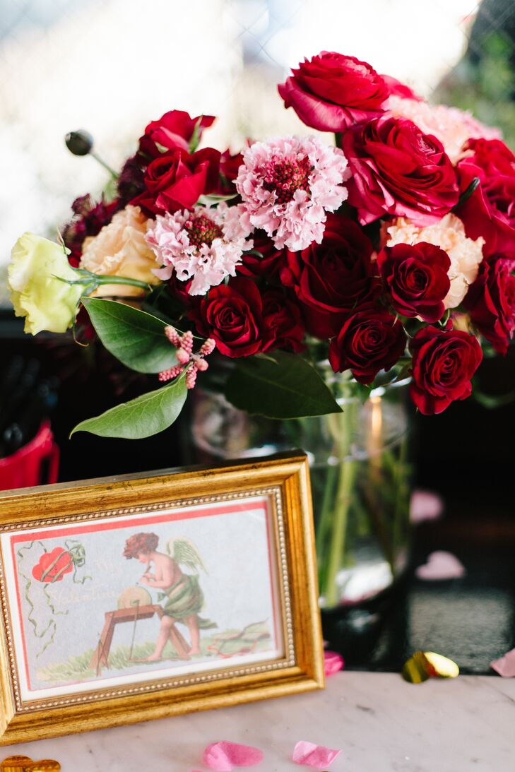 The couple embraced a vibrant Valentine's Day motif for their big day. "One of our favorite details was the vintage, framed Valentine's Day postcards," Allison says. "They each featured cartoon cupid's delivering love letters. Some of the postcards were over 100 years old!"