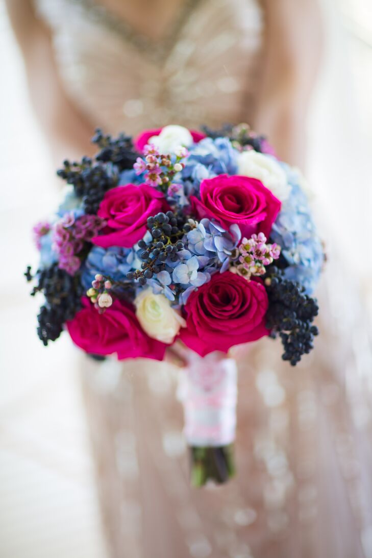 For an added element of texture, Galina and Andrew's florist  mixed dark blue berries into Galina's bright pink and blue bridal bouquet.