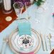 Place Setting With Teal-and-Pink Napkin and Gold Flatware