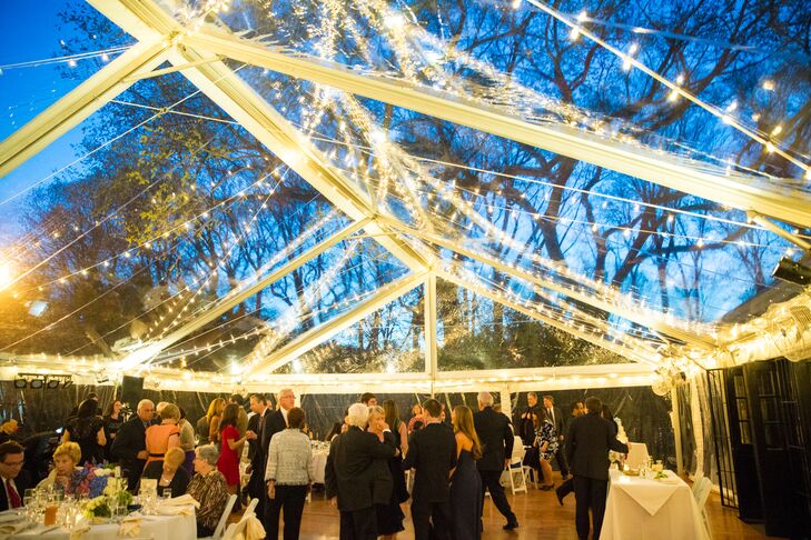 The reception was held in a 5,000-square-foot clear tent with strings of white lights to illuminate the night. "Throughout the reception, the sky changed from light blue to a deep dark navy, with the moon and the stars visible from the dance floor," Lisa says. "It was truly magical."