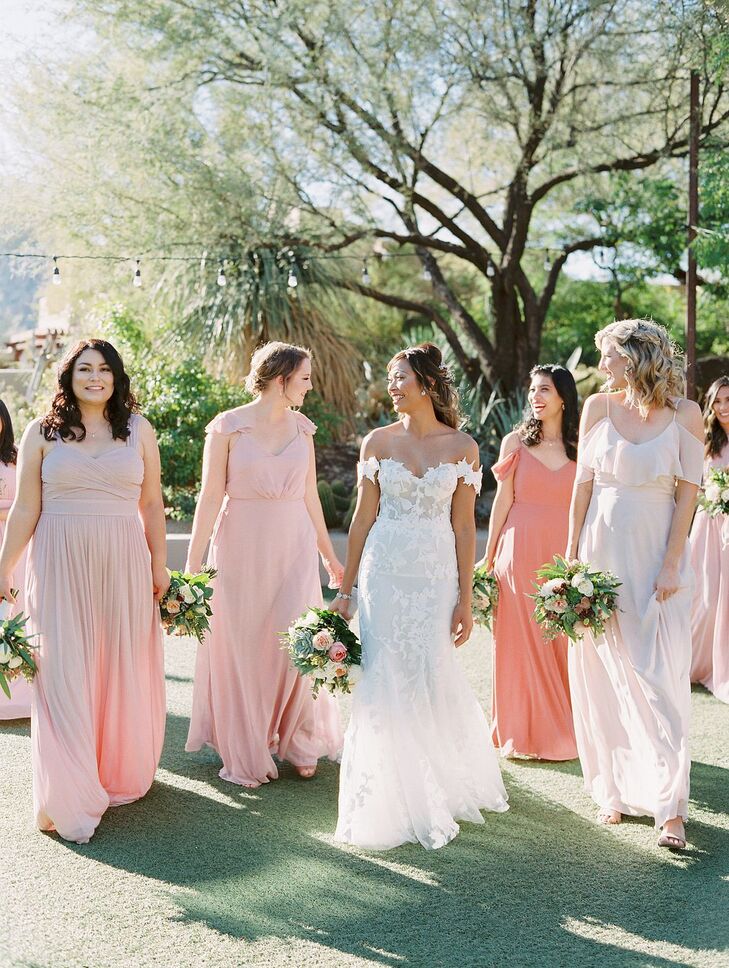 Bride Walking Beside Bridesmaids in Peach-Hued Dresses
