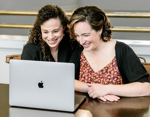 Engaged couple starting their wedding registry on laptop at home