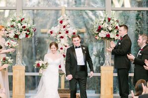 Bride and Groom with Floral Cross at Wedding Ceremony