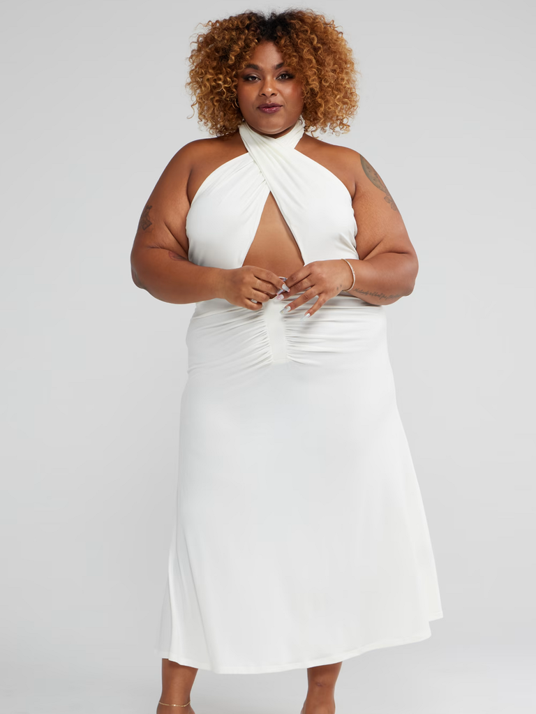 A model shows off this stunning white halter-neck gown with a keyhole waist.