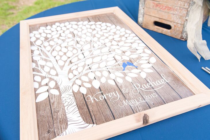 Rachael and Korey picked a guest book that fit their style to a T. Their 150 friends and family members were asked to sign a tree-inspired poster with well wishes and advice. Wood covered the background, while two blue lovebirds were nestled in the tree.