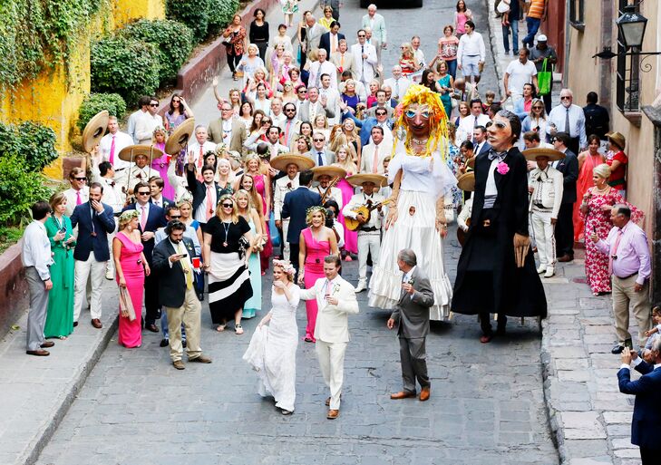 The traditional San Miguel de Allende recessional parade with mojigangas was an experience like no other for Louisa and Joseph's 160 wedding guests. They paraded through the streets of San Miguel de Allende with larger-than-life papier-mache mojigangas and tequila shot glasses around their necks, which they could fill with tequila carried by a donkey!