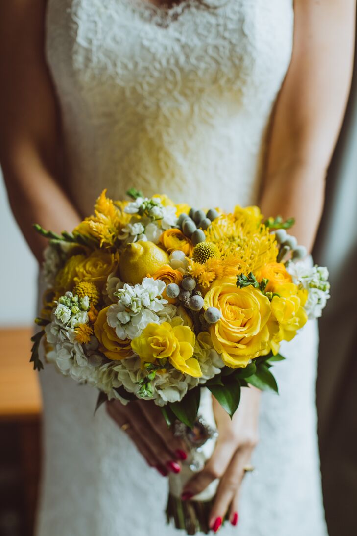 Drawing on the affair’s lemon theme, the florists at the Metropolitan Plant Exchange incorporated a real lemon into Candice’s bouquet for a fun twist. The brilliantly hued bundle was a vibrant mix of roses, stock, hydrangeas, ranunculus, craspedia and more with silver brunia adding a touch of texture and drama.