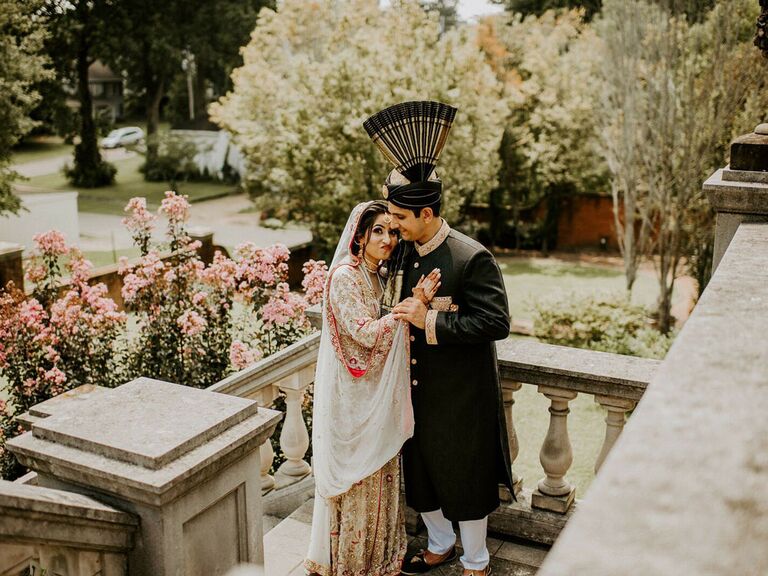 Bride and groom wearing multicultural ornate wedding fashion