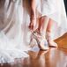 While the rest of Shelby’s look had a bohemian style, she picked shoes that were more structured. Designed by Jessica Simpson, the peep-toe heels had lace detailing along the ankles and ivory satin lining.