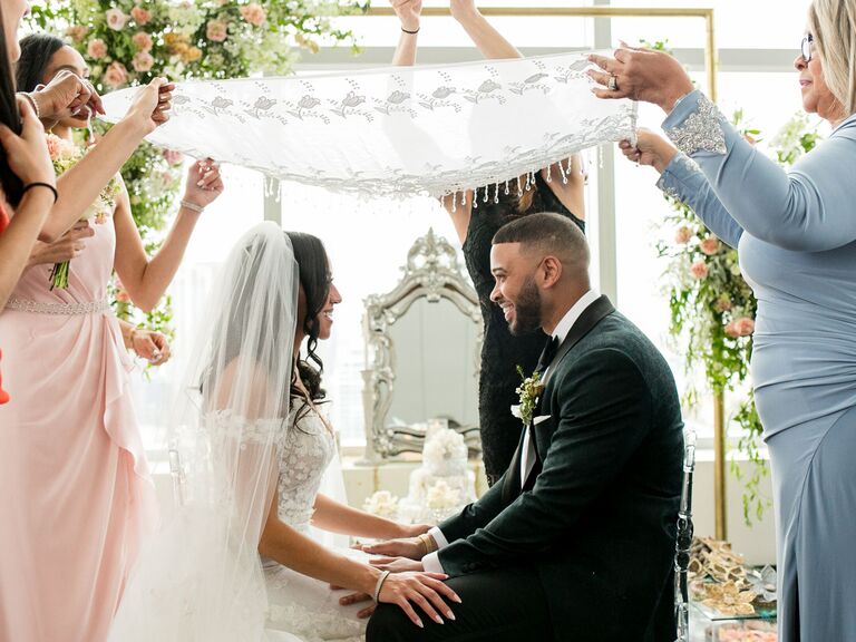Couple exchanging vows at aisle