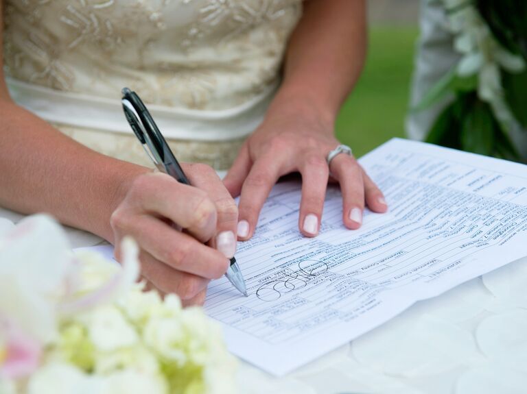 Bride signing paperwork