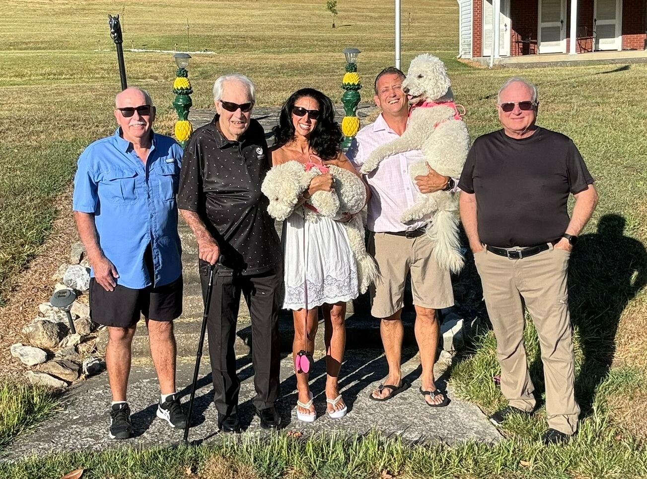 Summer smiles all around—Dad, Granddaddy, Tara, Barry, the pups, and Kevin soaking up the sun before Tara's birthday dinner.  Barry went all out for this birthday with dinner, a cake and best of all - family!