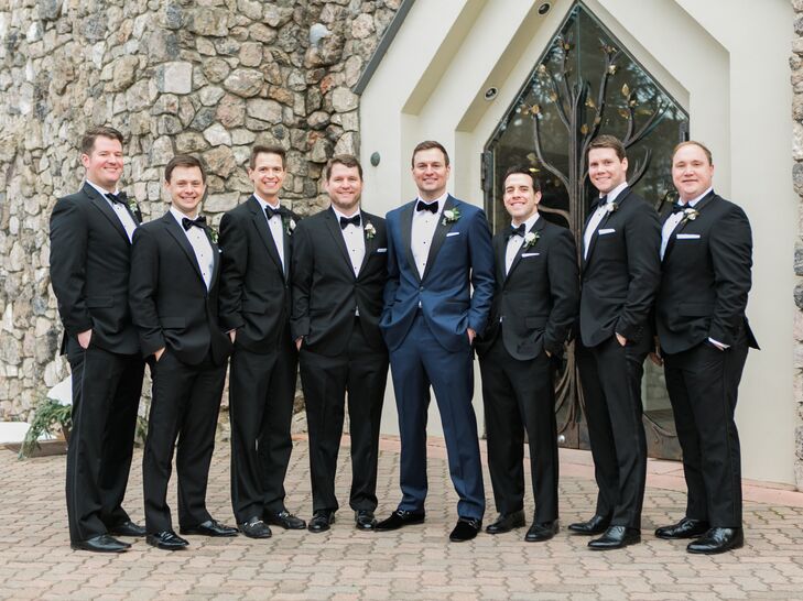 The groom designed his midnight navy tux, selecting everything from the fabric to the buttons. The wedding date was monogrammed on the back of his collar, and the couple’s crest was added to the lining. He added velvet shoes and fleur-de-lis socks in honor of his hometown of Louisville, Kentucky. The groomsmen wore their own traditional black tuxes.
