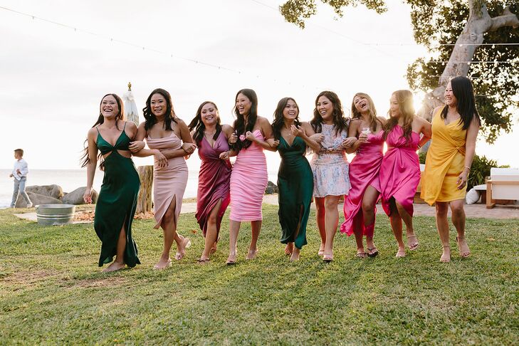 Women in Different Semi-Formal Dresses Walk Arm-in-Arm on Lawn in Hawaii