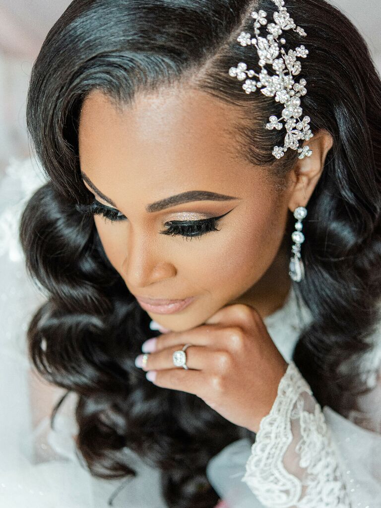 Bride getting ready wearing glam sparkly hair pin with old Hollywood waves
