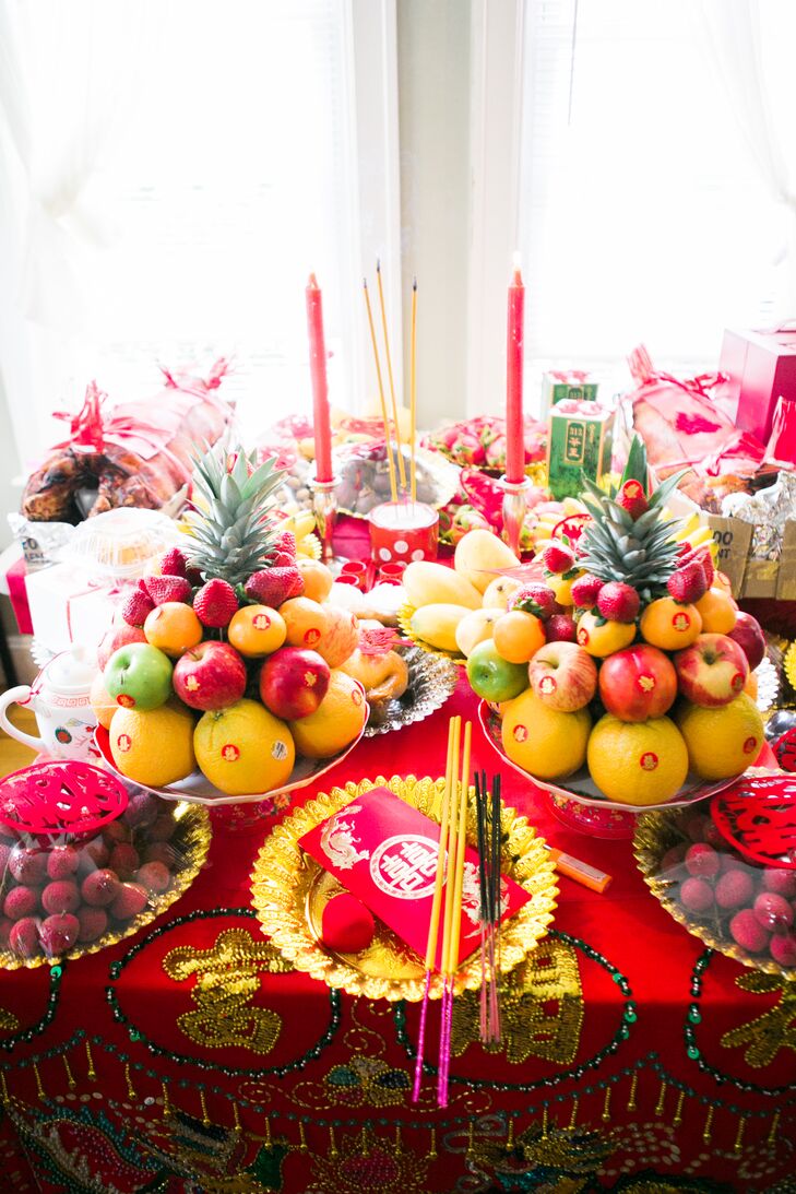 Paying tribute to their Chinese and Cambodian cultural heritage was important to both LeiLei and Lanay, so an Asian-inspired theme was a given. The couple chose a color palette of red and gold and incorporated traditional symbols like double-happiness, dragons and phoenixes throughout. “We really wanted to include the traditions of our families for the wedding,” says LeiLei.