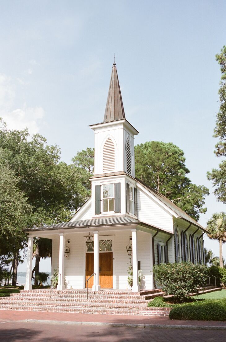 The ceremony was held at the quaint waterside chapel on the May River. White rose petals lined the aisles, and simple vases of hydrangeas were placed at the end of the pews.
