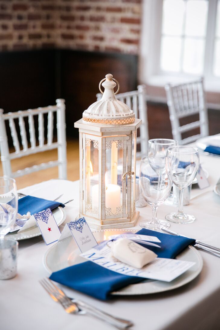 For a more modern feel, Shayna and Josh opted to alternate between floral and non-floral centerpieces for their reception tables. Vintage-inspired carriage lanterns filled with ivory pillar candles played into the wedding’s coastal undertones and cast a warm, ambient glow over the tables. “We had silver lanterns everywhere that my mother purchased from various stores,” says Shayna. “We wanted that twinkling light effect and to have just as much silver everywhere as navy.”