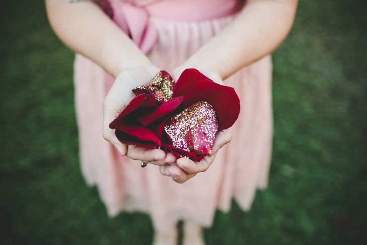 The couple's niece, Maggie, was the flower girl and tossed glitter-covered rose petals as she made her way down the aisle.