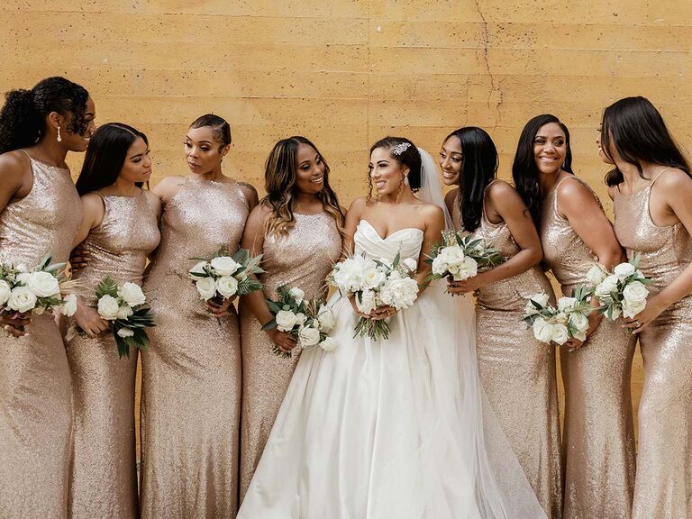 bride and bridesmaids wearing gold gowns and carrying white bouquets