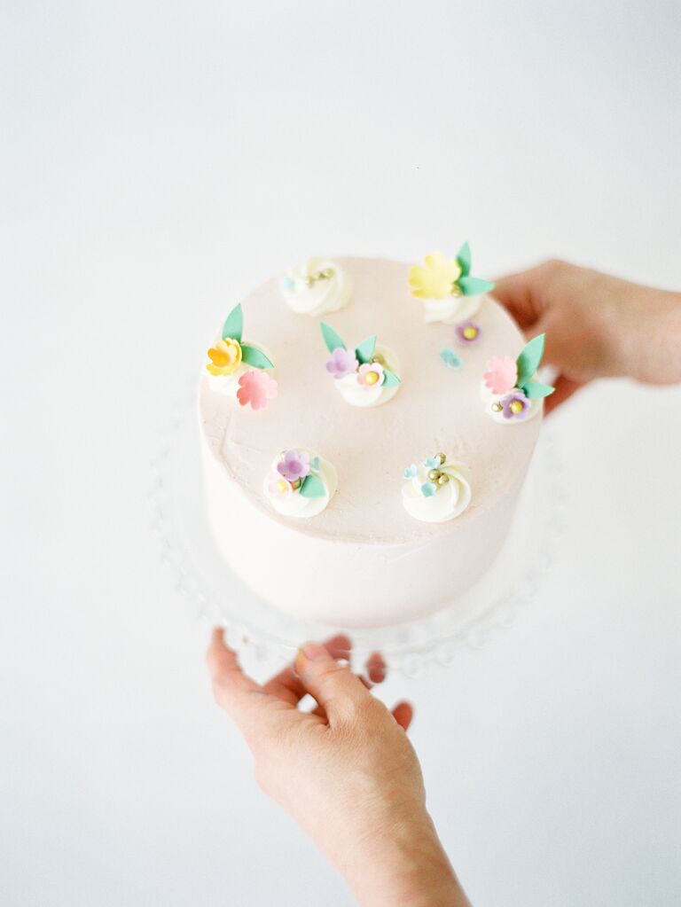 small wedding cake decorated with pastel sugar flowers