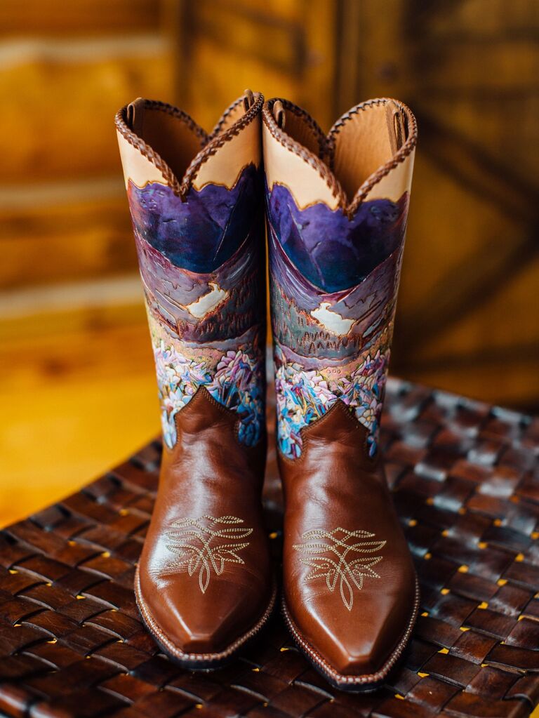Custom hand-painted cowboy boots depicting a beautiful landscape. 