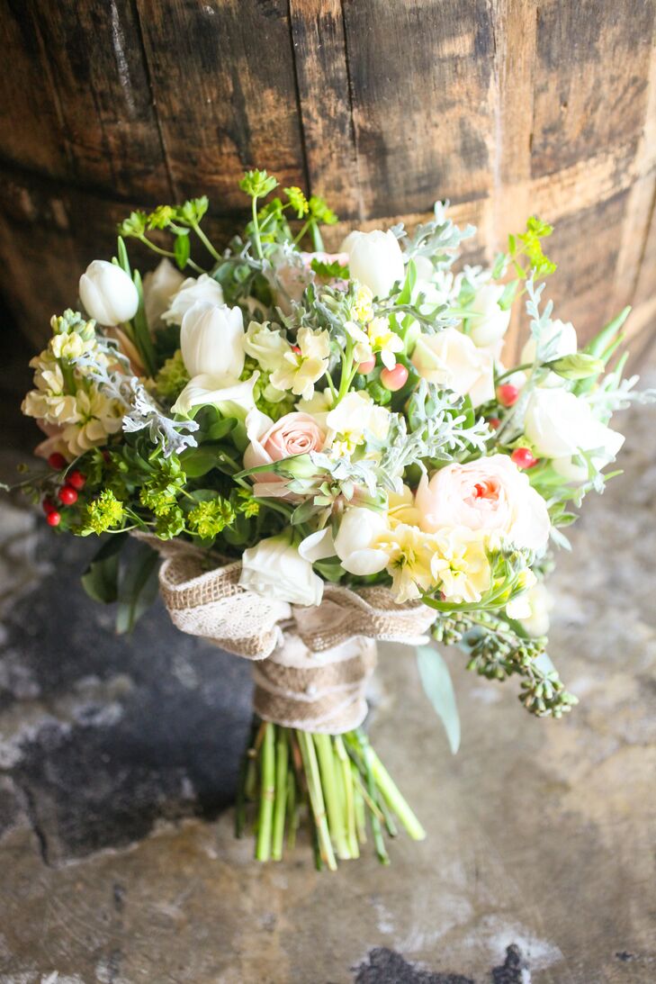 “The flowers absolutely brought the whole wedding together,” says Chelsea. She carried a bouquet of white tulips, blush roses, blush peonies, yellow orchids, white roses and red hypericum berries down the aisle. It was arranged by Redman Steele Floral Design Studio.