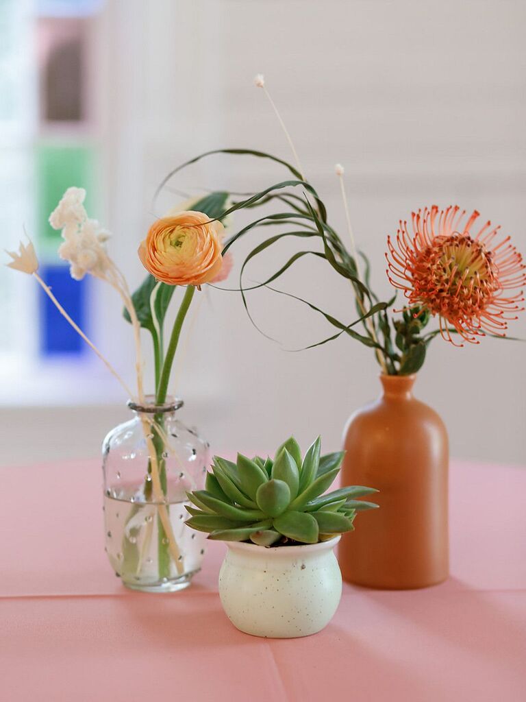 Bud vases with protea blooms, ranunculus and succulents