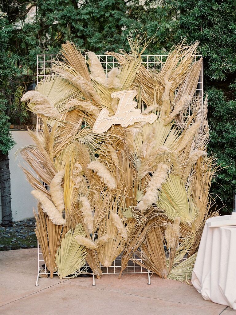 Decorative wall with dried grasses and custom sign