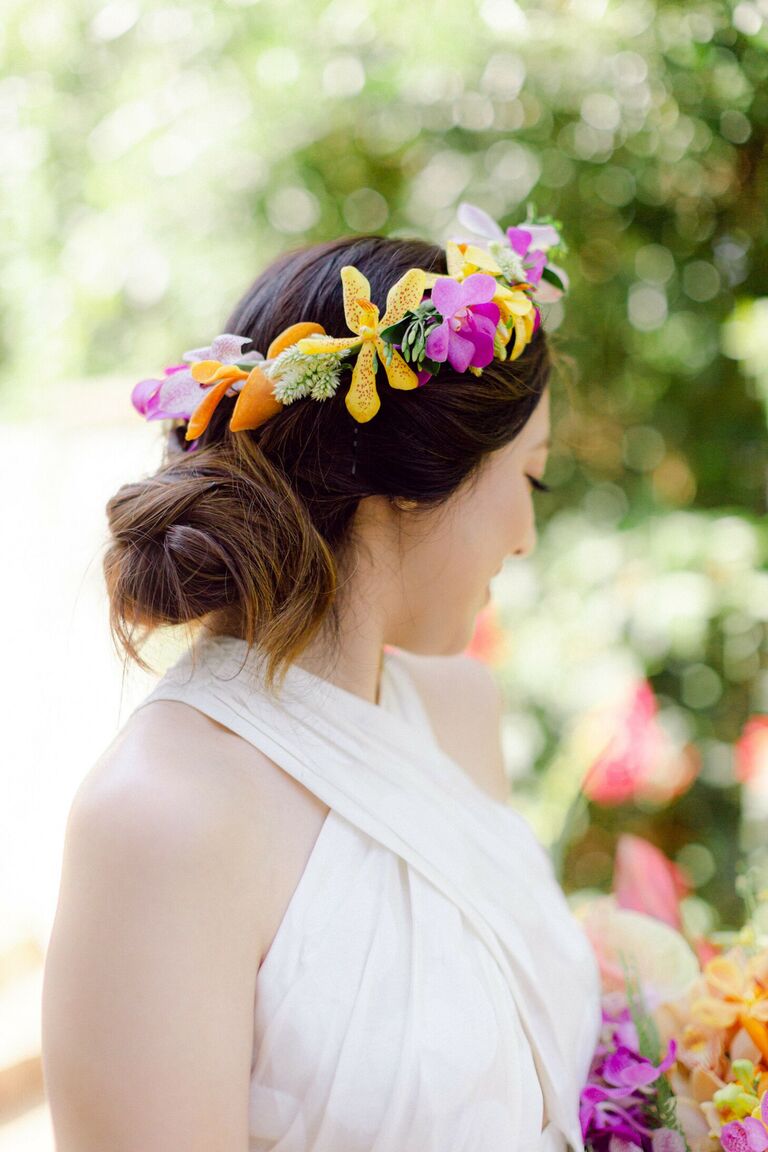 Bride wearing flower crown with orchids