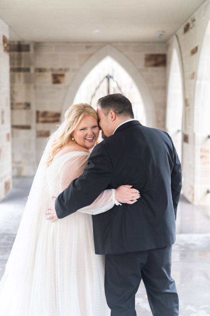 Bride in a Swiss Dot Dress and Groom in a Suit Turning Back to Camera