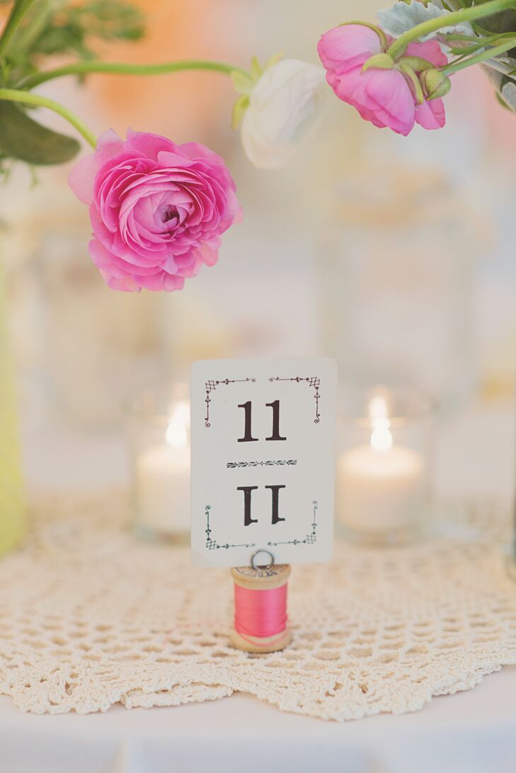 Vintage playing cards were used at the table numbers and were held up by spools of pink thread.