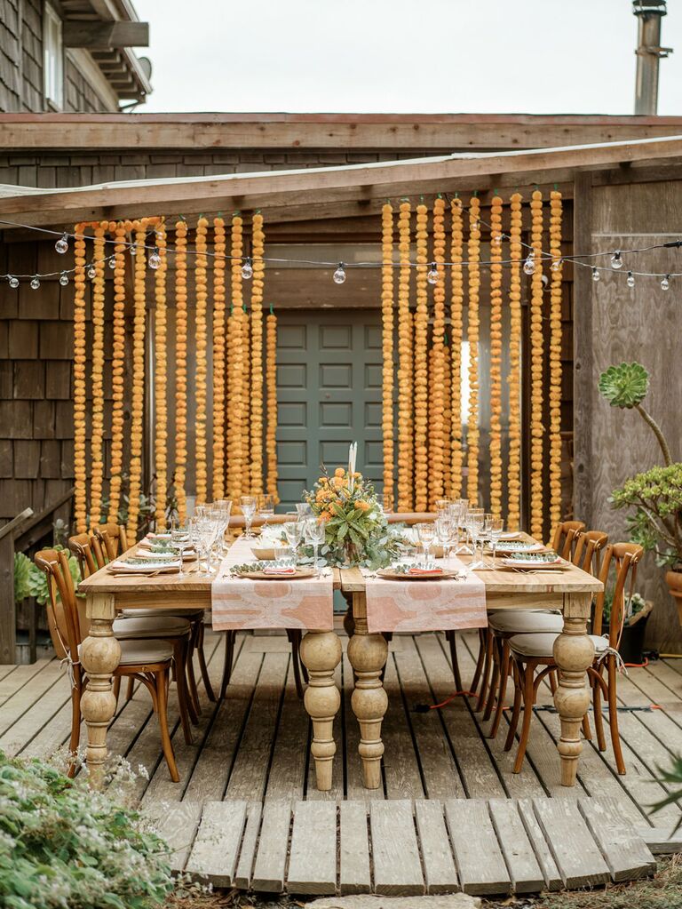Yellow marigold garlands at outdoor boho wedding