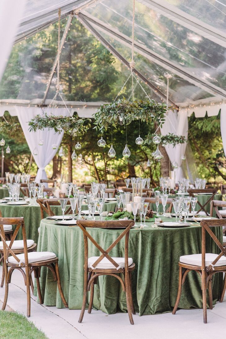 Woodland-Themed Wedding Reception With Hanging Greenery and Green Linens