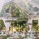 Woodland-Themed Wedding Reception With Hanging Greenery and Green Linens