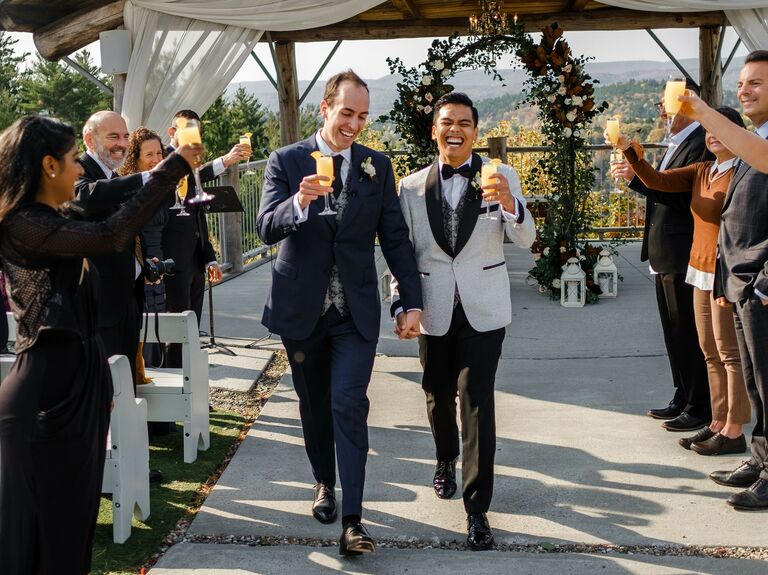 Grooms walk down the aisle after their wedding ceremony. 