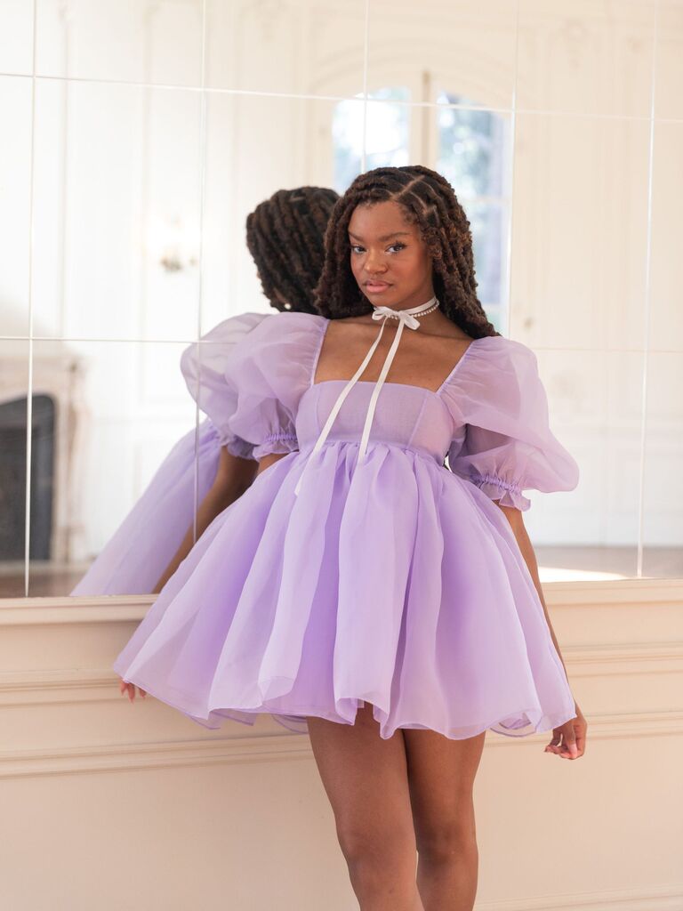 Light purple mini dress with puffed sleeves and a full skirt. 