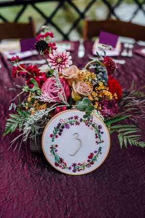 Hand-Sewn Table Numbers with  Vibrant Flower Centerpieces